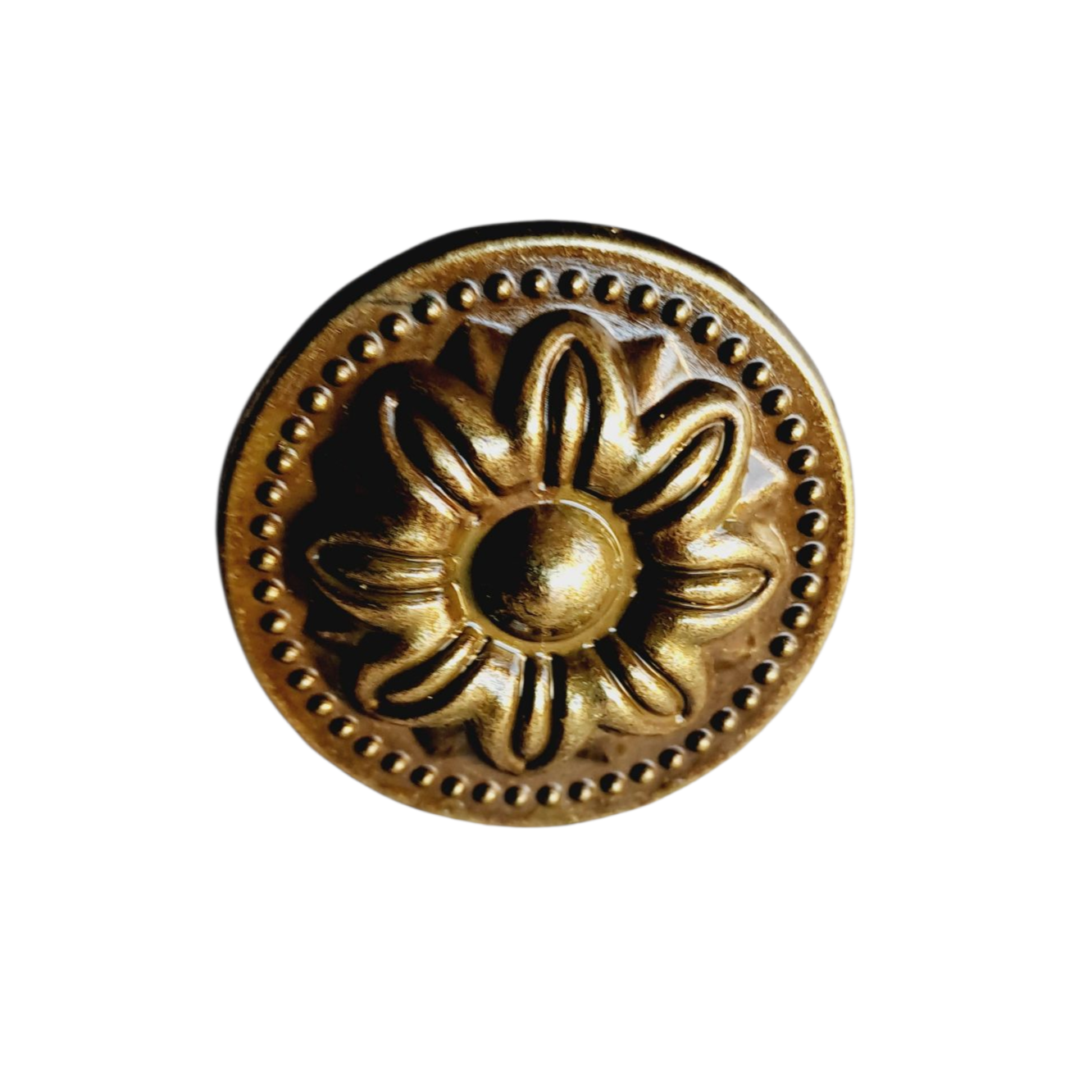 Decorative brass button with floral design on a white background