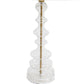 Table lamp with a white shade and clear, ribbed base on a white background