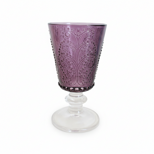 Purple embossed glass with a clear stem on a white background
