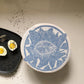 Decorative plate with blue floral design on a neutral background