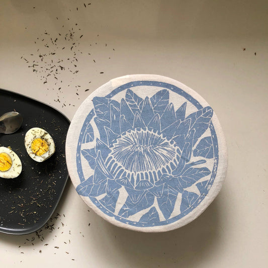 Decorative plate with blue floral design on a neutral background