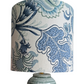 Lamp with a decorative blue and white floral patterned shade on a white background