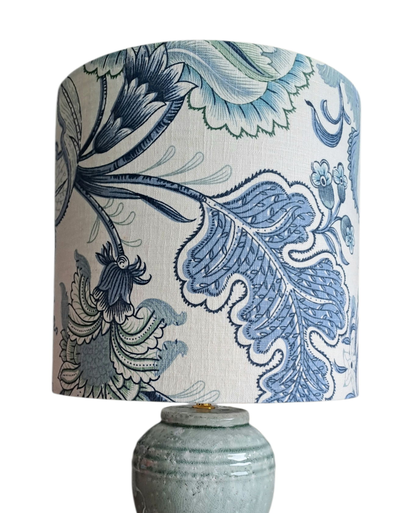 Lamp with a decorative blue and white floral patterned shade on a white background