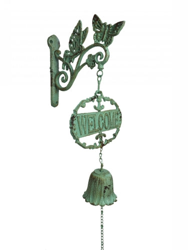 A distressed green metal wall-mounted decorative sign with butterfly wings, a hanging 'WELCOME' plaque, and a bell-shaped pull chain, shown on a plain white background.