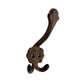 Decorative metal hook with intricate design on a white background