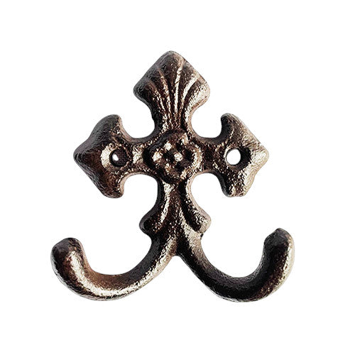 Decorative metal double hook with intricate design on a white background