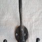 Black double hook on a textured gray background