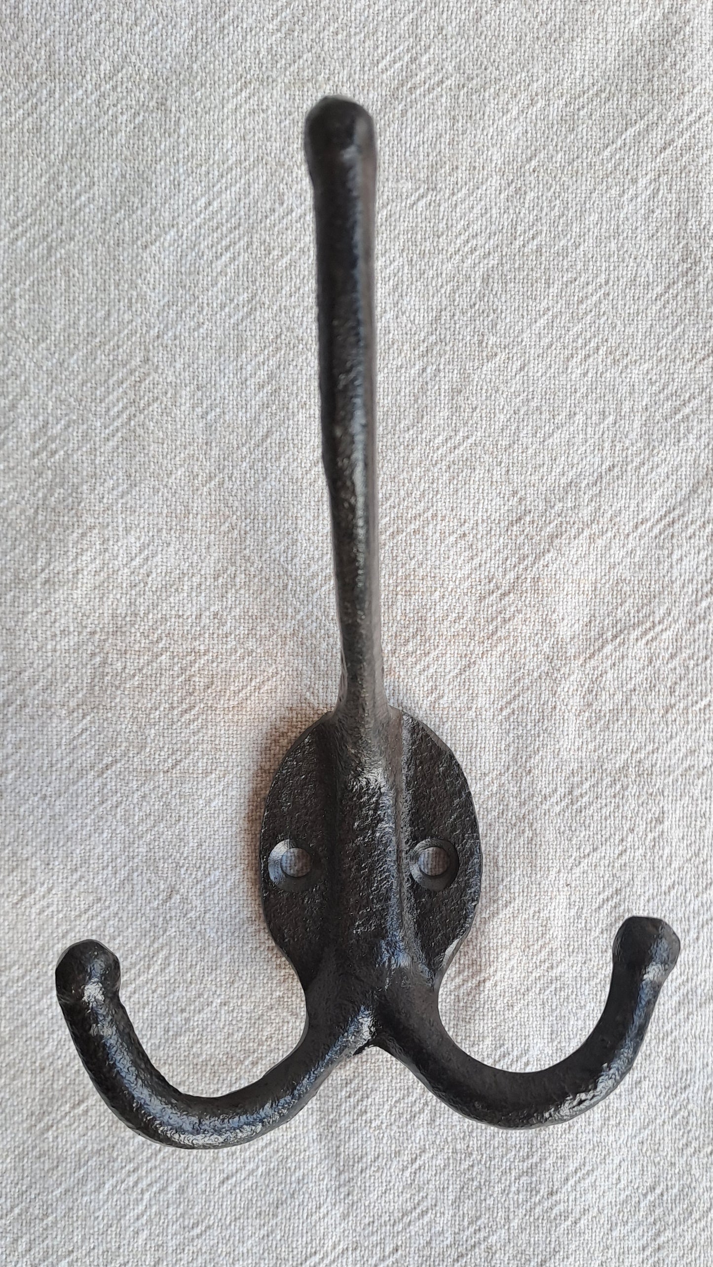 Black double hook on a textured gray background