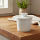 White ceramic butter container with lid on a white background