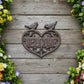 Decorative metal 'Welcome' sign with birds on a white background