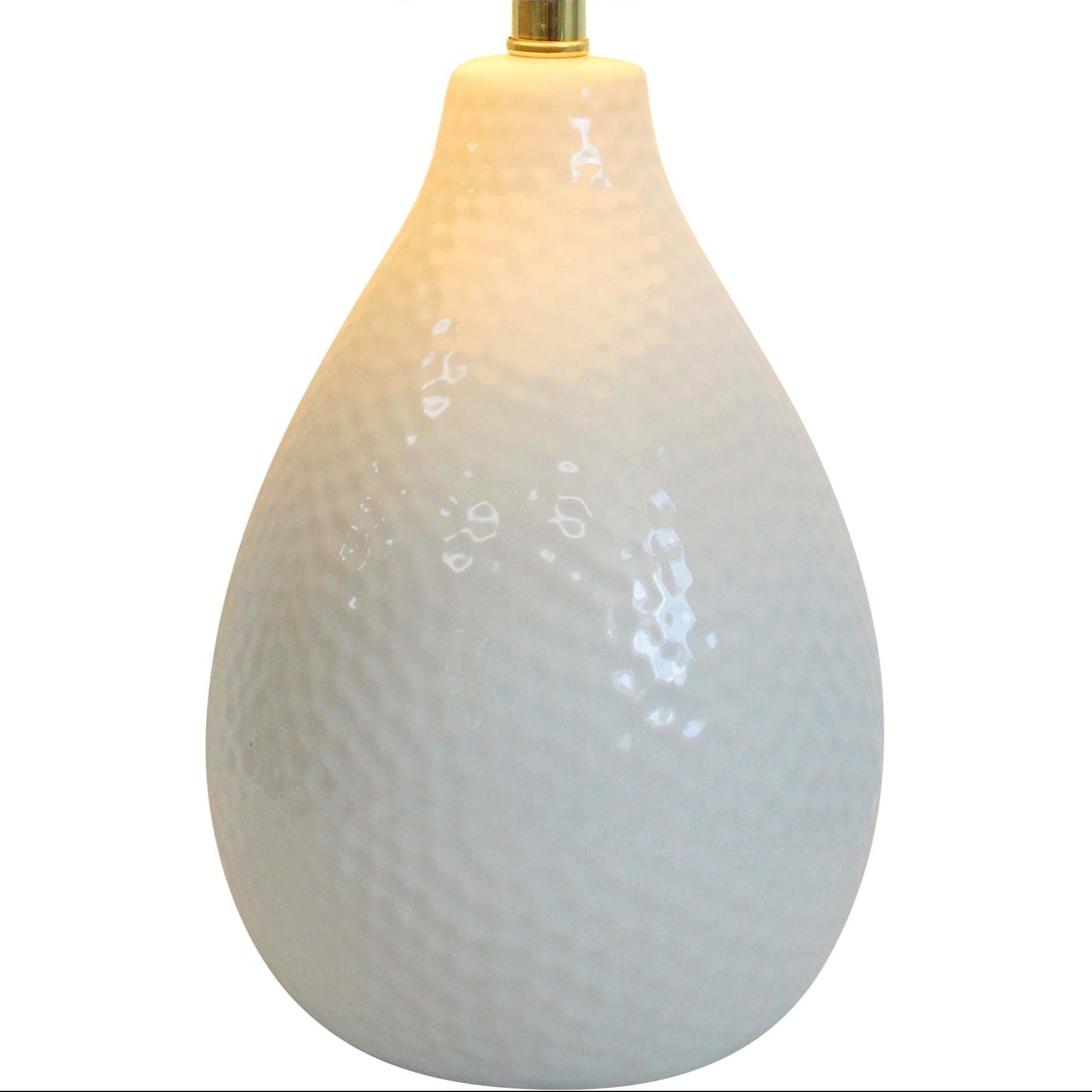 Table lamp with a textured white base and a beige fabric shade on a white background