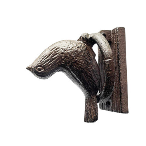 Decorative metal bird wall hook on a white background