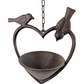 Decorative metal birdfeeder shaped like a heart with two birds on a white background