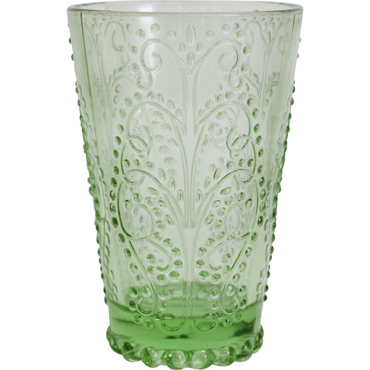 Green glass tumbler with decorative patterns on a white background