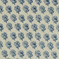 A close-up of a woven fabric pattern featuring a repeating navy blue floral block print on a warm beige linen-like background.