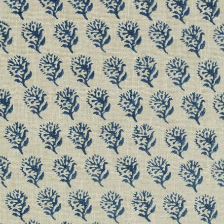 A close-up of a woven fabric pattern featuring a repeating navy blue floral block print on a warm beige linen-like background.