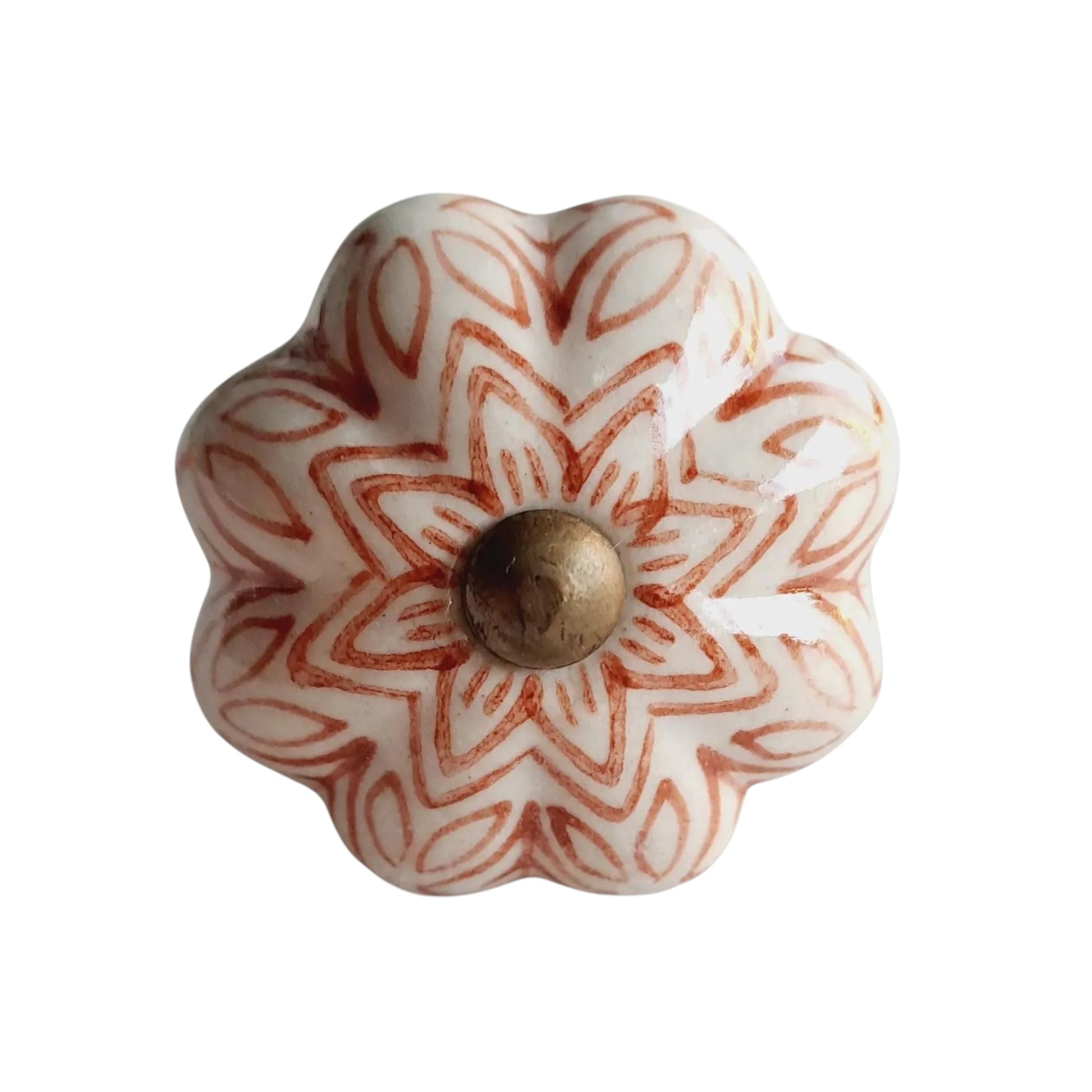 Decorative ceramic knob with floral pattern and gold center on a white background