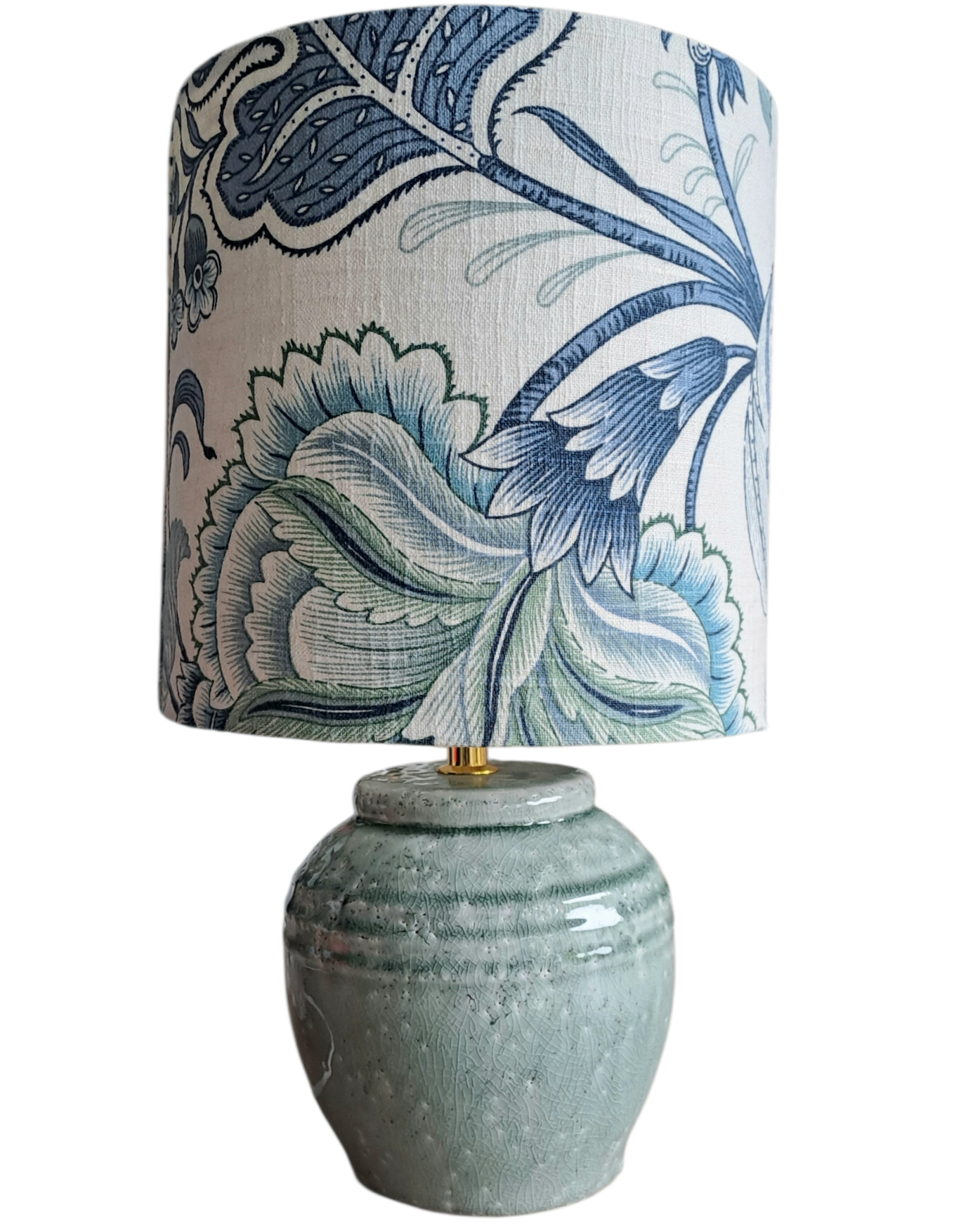 Table lamp with a decorative blue and white floral patterned shade on a white background