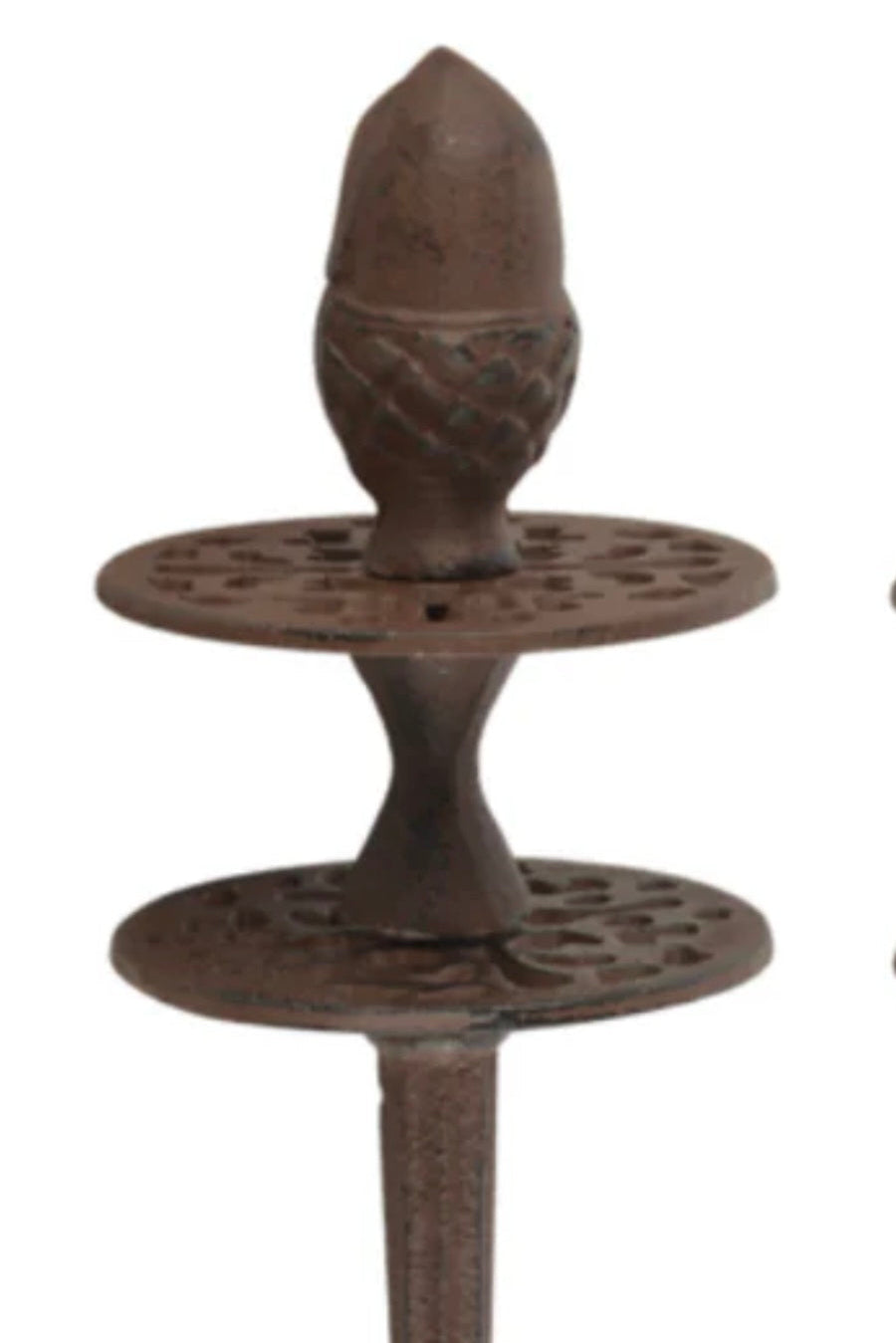 Decorative metal object with acorn design on a white background