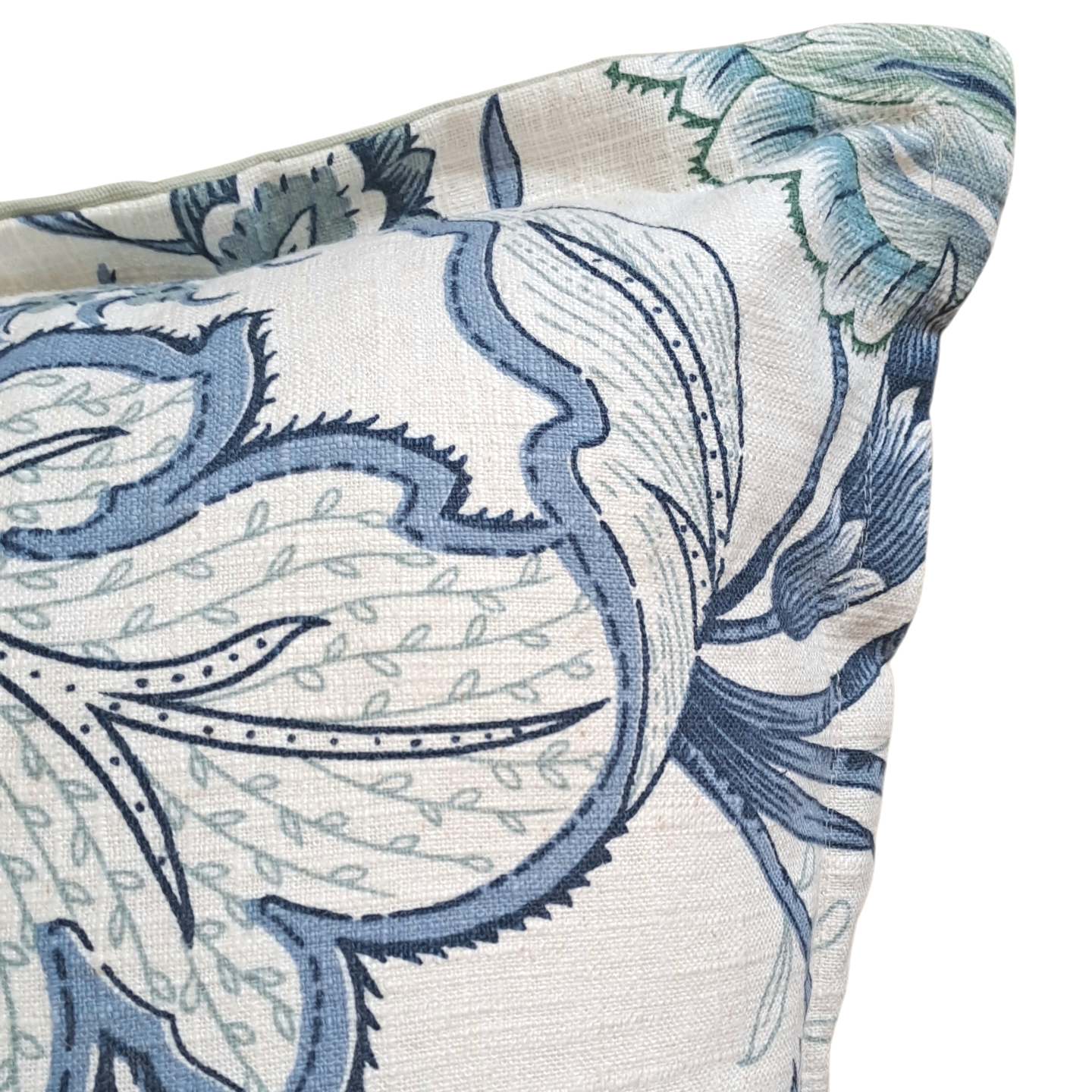 Close-up of a decorative pillow with blue and green floral pattern on a white background