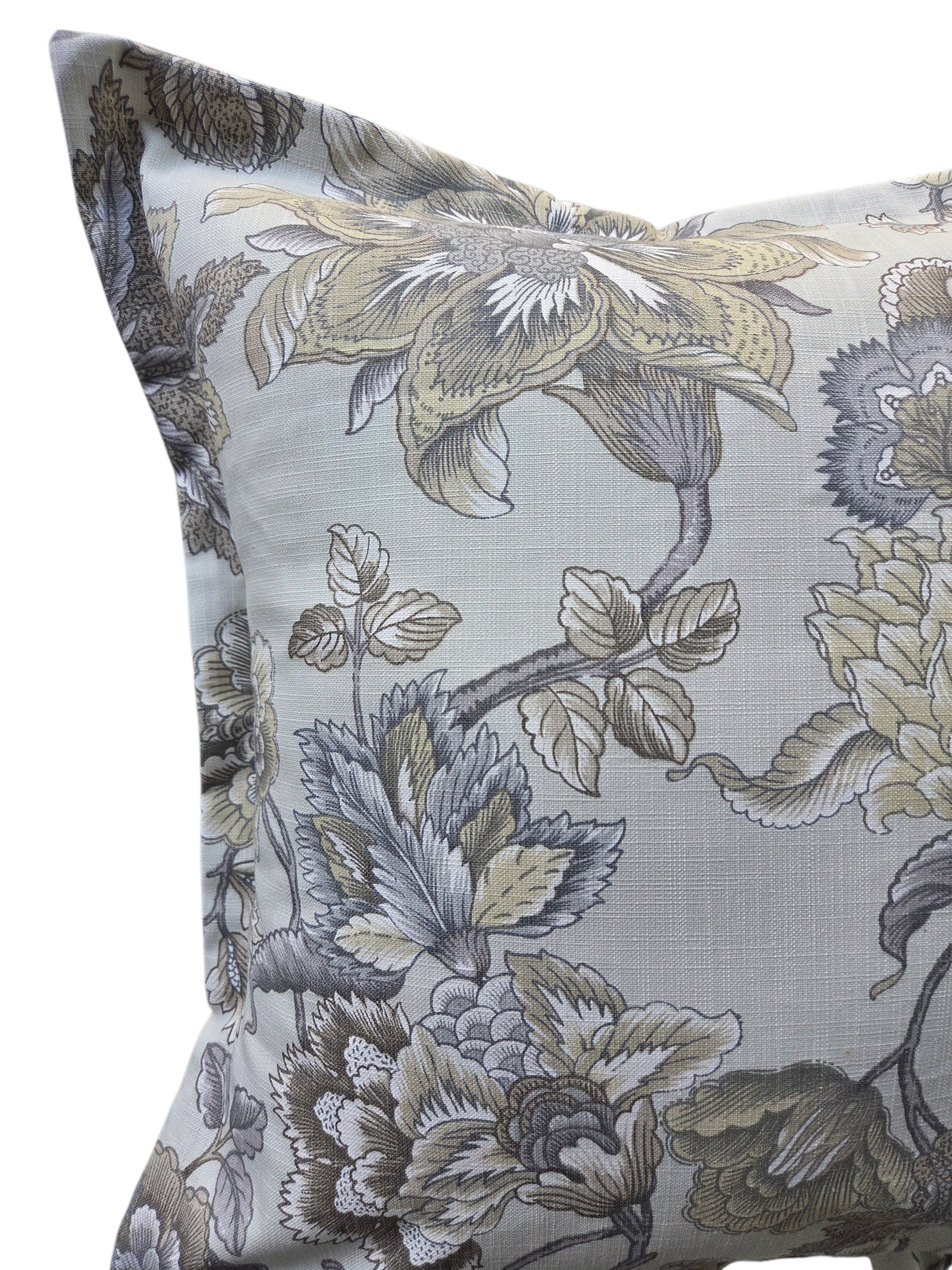 A square decorative throw pillow featuring a classic floral toile pattern in muted gray, beige, and olive green tones on a light gray background.