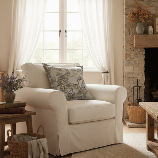 A square decorative throw pillow featuring an intricate floral damask pattern in muted gray, beige, and olive tones, set against a plain white background.