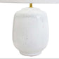 White textured table lamp with a white lampshade on a white background