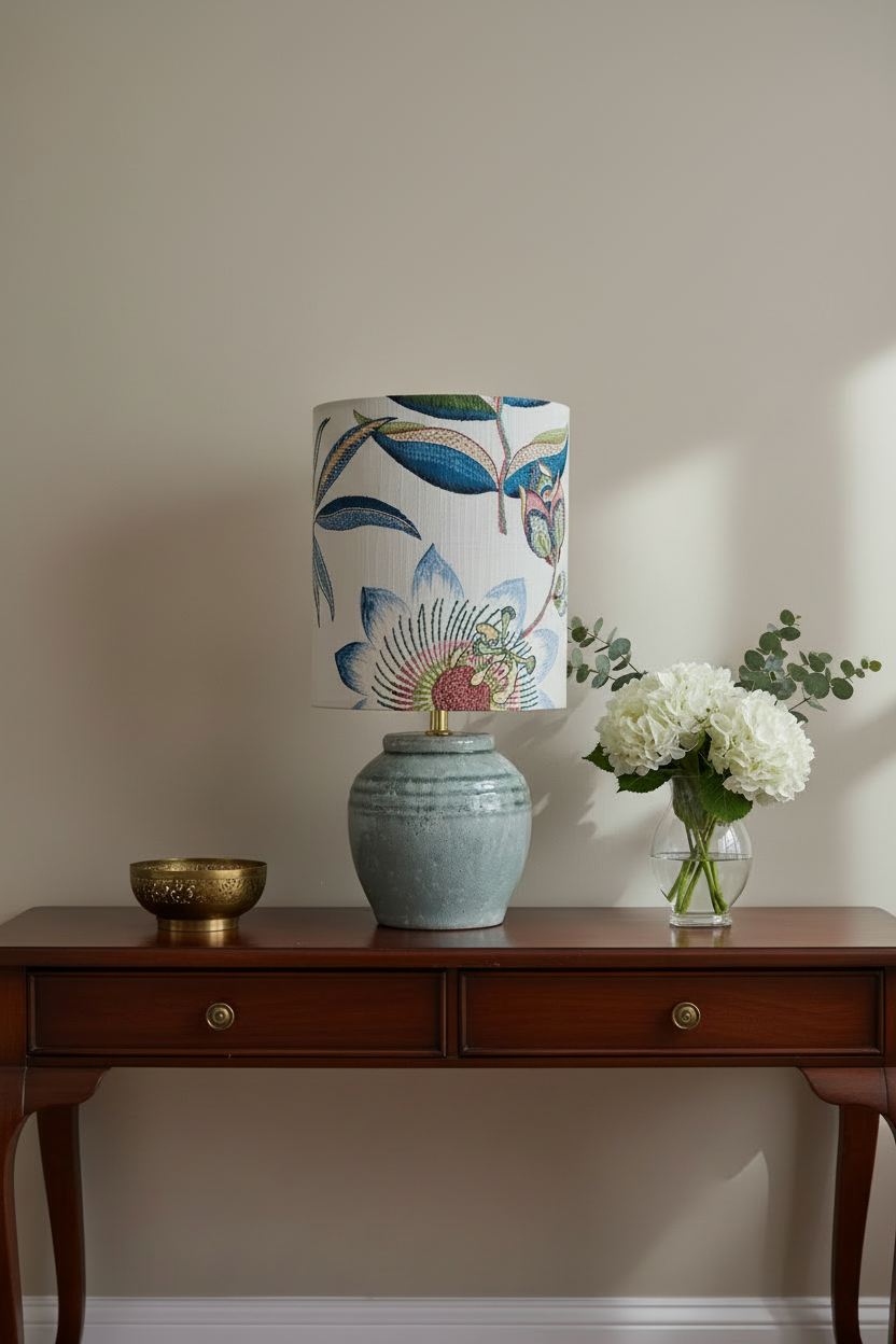Table lamp with a decorative floral-patterned shade and textured base on a white background