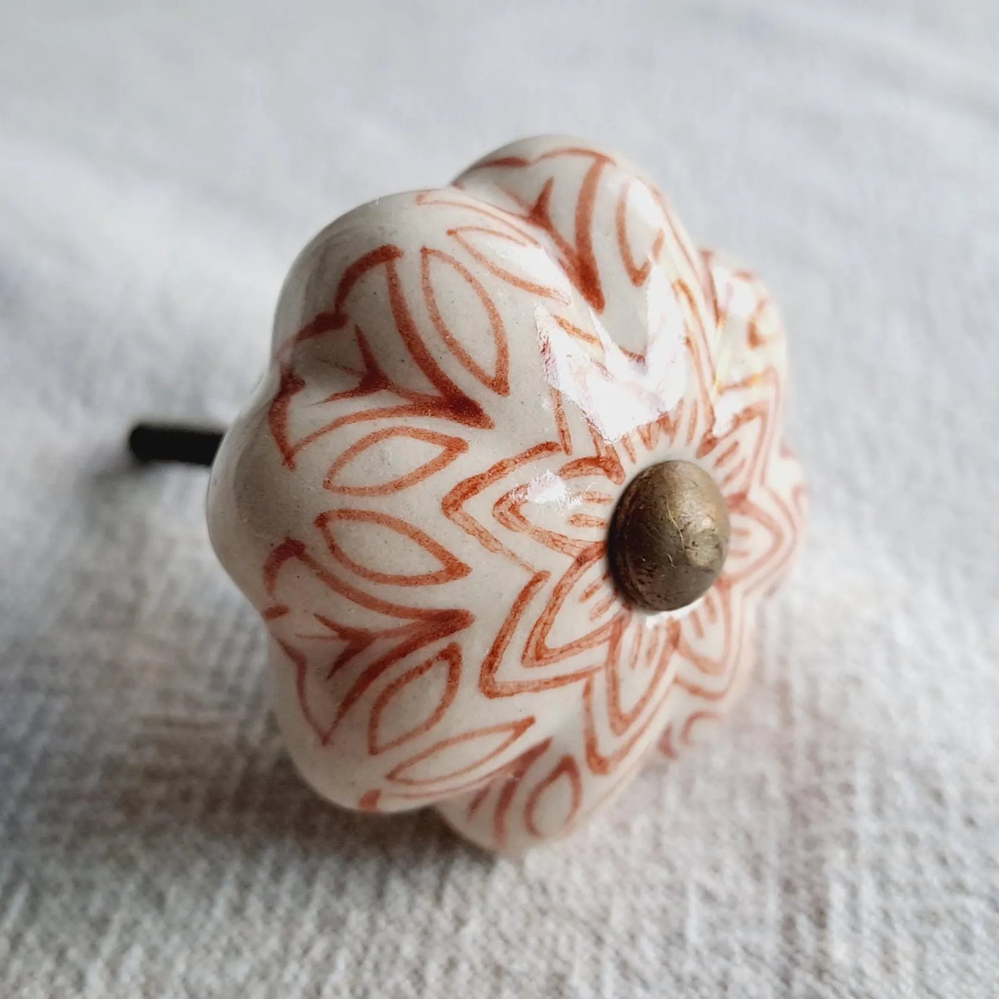 Ceramic knob with decorative pattern on a white background