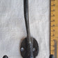 Double wall hook with a ruler for scale on a gray background